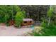 Quaint cedar cabin with a rustic exterior, surrounded by lush greenery and mature trees at 8537 S Doubleheader Hwy, Morrison, CO 80465