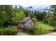Charming home surrounded by lush greenery and mature trees with a lovely deck in a secluded setting at 8537 S Doubleheader Hwy, Morrison, CO 80465