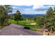 Backyard view showcases horse corral, trees, and distant hills at 8537 S Doubleheader Hwy, Morrison, CO 80465