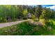 Charming home nestled among lush greenery, featuring a rustic exterior and welcoming curb appeal at 8537 S Doubleheader Hwy, Morrison, CO 80465