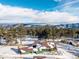 Charming green home boasts stunning mountain views and a snow-covered roof at 8537 S Doubleheader Hwy, Morrison, CO 80465