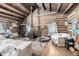 Charming log cabin living room featuring rustic wood walls, a wood-burning stove, and cozy furniture at 8537 S Doubleheader Hwy, Morrison, CO 80465