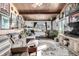 Eclectic living area with a wood ceiling, a cozy couch, and a wood-burning stove at 8537 S Doubleheader Hwy, Morrison, CO 80465