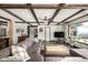 Stylish living room with exposed wood beams, a comfortable sectional sofa, and scenic views at 8537 S Doubleheader Hwy, Morrison, CO 80465