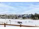 Scenic view of horses grazing on a snow-covered field with mountains in the background and homes in the valley at 8537 S Doubleheader Hwy, Morrison, CO 80465
