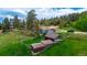 Aerial view of property featuring outbuildings, and mature trees at 8537 S Doubleheader Hwy, Morrison, CO 80465