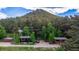 Aerial view of property featuring outbuildings, mature trees, and serene mountain views at 8537 S Doubleheader Hwy, Morrison, CO 80465