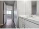 Bathroom with white vanity and view of bedroom at 3047 W 47Th Ave # 506, Denver, CO 80211