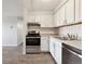 Modern kitchen with white cabinets and stainless steel appliances at 3047 W 47Th Ave # 506, Denver, CO 80211