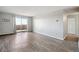 Living room with wood-look floors and access to a balcony at 3047 W 47Th Ave # 506, Denver, CO 80211