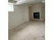 View of a basement area with a window and fireplace at 554 E Pleasant Ave, Byers, CO 80103