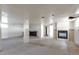 Large unfinished basement with a fireplace, bar, and ample space for various uses at 554 E Pleasant Ave, Byers, CO 80103