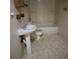 View of a bathroom with a bathtub and a pedestal sink at 554 E Pleasant Ave, Byers, CO 80103