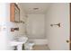 Small, outdated bathroom with tub, toilet and sink awaiting updates at 554 E Pleasant Ave, Byers, CO 80103
