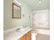Bathroom featuring a shower-tub combo, single sink vanity and mirror at 554 E Pleasant Ave, Byers, CO 80103