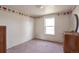 Cozy bedroom features neutral walls, carpet flooring and a heart-themed border at 554 E Pleasant Ave, Byers, CO 80103