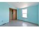 Bright bedroom with blue walls and closet at 554 E Pleasant Ave, Byers, CO 80103