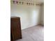 View of a bedroom with blank walls and a colorful heart decorated border near the ceiling at 554 E Pleasant Ave, Byers, CO 80103