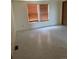 Bedroom with tiled floors, two windows, and a closet at 554 E Pleasant Ave, Byers, CO 80103