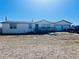 Ranch-style home with a two-car garage, deck, and a large front yard at 554 E Pleasant Ave, Byers, CO 80103