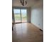 Living room with hardwood floors, sliding glass doors to deck, and an outlet at 554 E Pleasant Ave, Byers, CO 80103