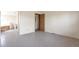 Primary bedroom with vinyl flooring and access to the main bath at 554 E Pleasant Ave, Byers, CO 80103