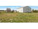 View of buildings on property, including garage, shed, and storage areas at 554 E Pleasant Ave, Byers, CO 80103