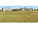 View of land featuring the house, outbuildings, and surrounding greenery at 554 E Pleasant Ave, Byers, CO 80103