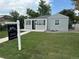 Charming single-story home with a well-manicured lawn, gray siding, and a cozy front porch perfect for relaxing at 1125 Nome St, Aurora, CO 80010