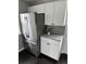 Well-equipped kitchen featuring a stainless steel refrigerator, granite countertops, and ample storage with white cabinets at 1125 Nome St, Aurora, CO 80010