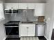 Modern kitchen featuring stainless steel appliances, granite countertops, and a stylish subway tile backsplash at 1125 Nome St, Aurora, CO 80010