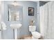 Clean bathroom with white pedestal sink and shower at 1440 Little Raven St # 204, Denver, CO 80202