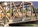 Rustic metal bridge over a waterway with train tracks below at 1440 Little Raven St # 204, Denver, CO 80202