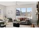 Comfortable living room with gray sofa and city views at 1440 Little Raven St # 204, Denver, CO 80202