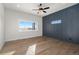 Light-filled bedroom with wood floors, ceiling fan and window views at 1369 Burt Ave, Berthoud, CO 80513