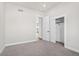 Bedroom with grey carpet, closet, and door to hallway at 1369 Burt Ave, Berthoud, CO 80513