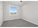 Bedroom with carpet, window, and view of neighboring house at 1369 Burt Ave, Berthoud, CO 80513