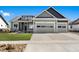 Attractive home with a 3-car garage, manicured lawn, and stone veneer accents at 1369 Burt Ave, Berthoud, CO 80513