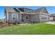 Charming gray single-Gathering home features a well-manicured lawn and stone accents at 1369 Burt Ave, Berthoud, CO 80513