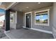 Covered front porch boasts stone accents, neutral colors, and ample natural light at 1369 Burt Ave, Berthoud, CO 80513