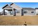 Gray siding two story house with covered patio at 1369 Burt Ave, Berthoud, CO 80513