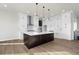 Modern kitchen with white cabinets, a large island, and stainless steel appliances at 1369 Burt Ave, Berthoud, CO 80513