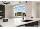 Kitchen island with sink, modern faucet, and built-in outlets at 1369 Burt Ave, Berthoud, CO 80513