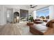 Living room with a brown sectional sofa, fireplace, and large windows at 1369 Burt Ave, Berthoud, CO 80513