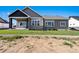 Backyard of a gray home featuring a spacious yard, ideal for outdoor activities at 1369 Burt Ave, Berthoud, CO 80513