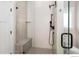 Large walk-in shower with textured tile and built-in seat at 1369 Burt Ave, Berthoud, CO 80513