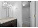 Bright bathroom featuring a modern vanity, updated fixtures, and a shower-tub combination at 7665 E Eastman Ave # D304, Denver, CO 80231