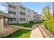 Apartment building featuring multiple stories with individual balconies and well-maintained landscaping at 7665 E Eastman Ave # D304, Denver, CO 80231