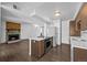 Spacious kitchen with modern appliances, breakfast bar, and a cozy fireplace in the living area at 7665 E Eastman Ave # D304, Denver, CO 80231