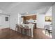 Open kitchen with a breakfast bar, wood cabinets, modern appliances, and a dining area at 7665 E Eastman Ave # D304, Denver, CO 80231